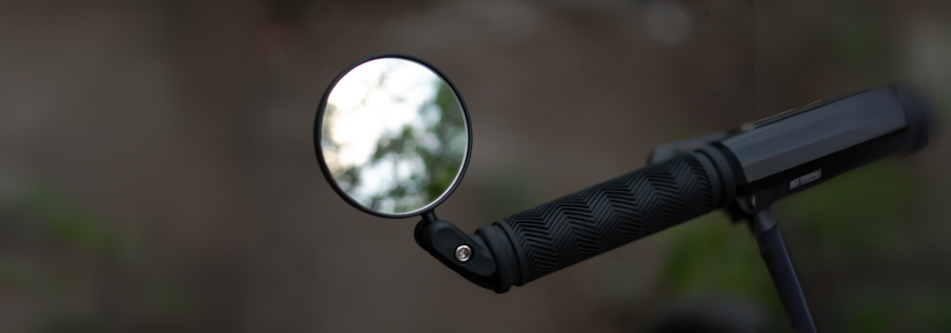 Lightweight helmet-mounted mirror with adjustable polycarbonate lens and rubber strap for commuter safety