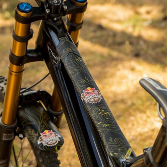 Matte black vinyl frame protectors matching bike color scheme while shielding against rock impacts