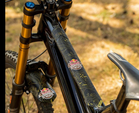 Matte black vinyl frame protectors matching bike color scheme while shielding against rock impacts