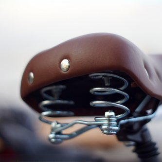 Lightweight race saddle with minimalist padding and titanium rails for efficient road cycling power transfer