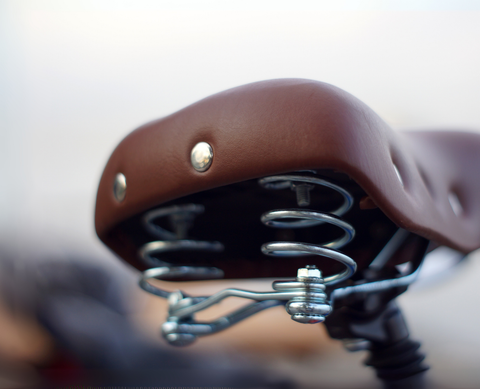 Lightweight race saddle with minimalist padding and titanium rails for efficient road cycling power transfer