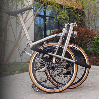 Compact folding bike frame with aluminum hinge joint and 20" wheels for urban commuting