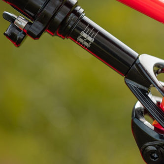 Close-up of shock sag indicator and rebound dial tuning for optimized downhill performance