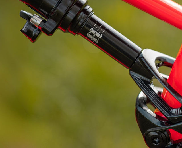 Close-up of shock sag indicator and rebound dial tuning for optimized downhill performance