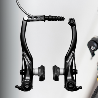 	Aluminum V-brake with parallel-arm design and cartridge pads, mounted on a touring bike rim for all-weather braking