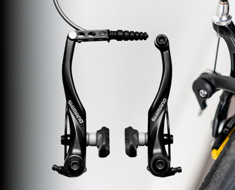	Aluminum V-brake with parallel-arm design and cartridge pads, mounted on a touring bike rim for all-weather braking
