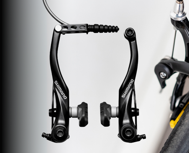 	Aluminum V-brake with parallel-arm design and cartridge pads, mounted on a touring bike rim for all-weather braking