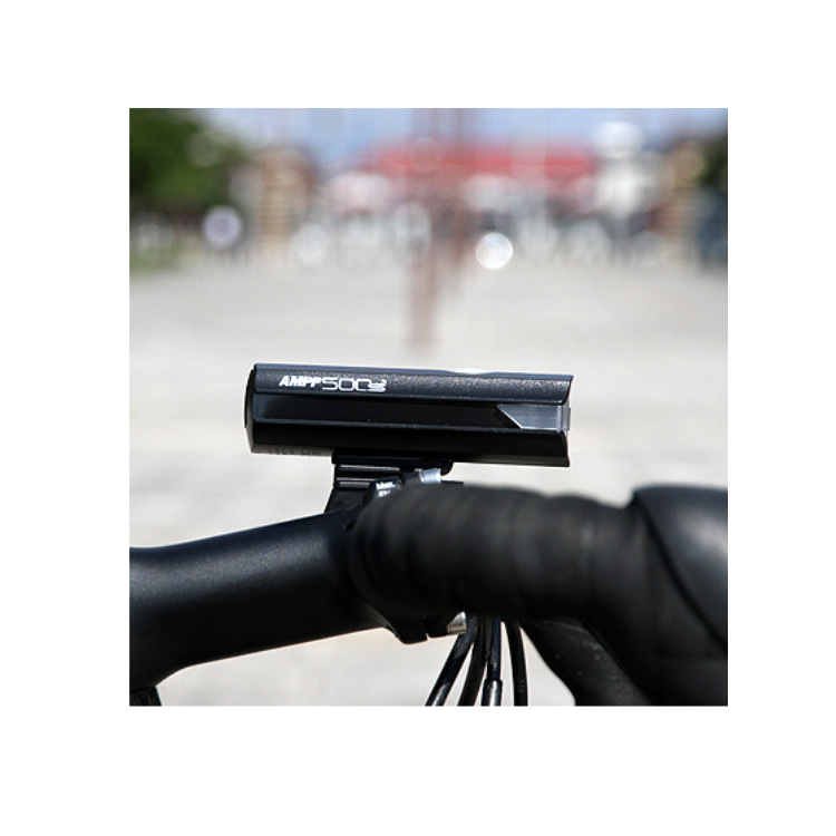 The AMPP500s front bike light mounted on a helmet, offering additional illumination and enhanced visibility for cyclists riding at night.