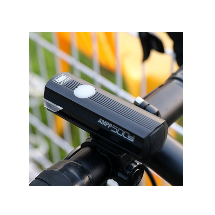 AMPP500s front bike light, featuring advanced LED technology, mounted on a bicycle handlebar for optimal night-time cycling safety.