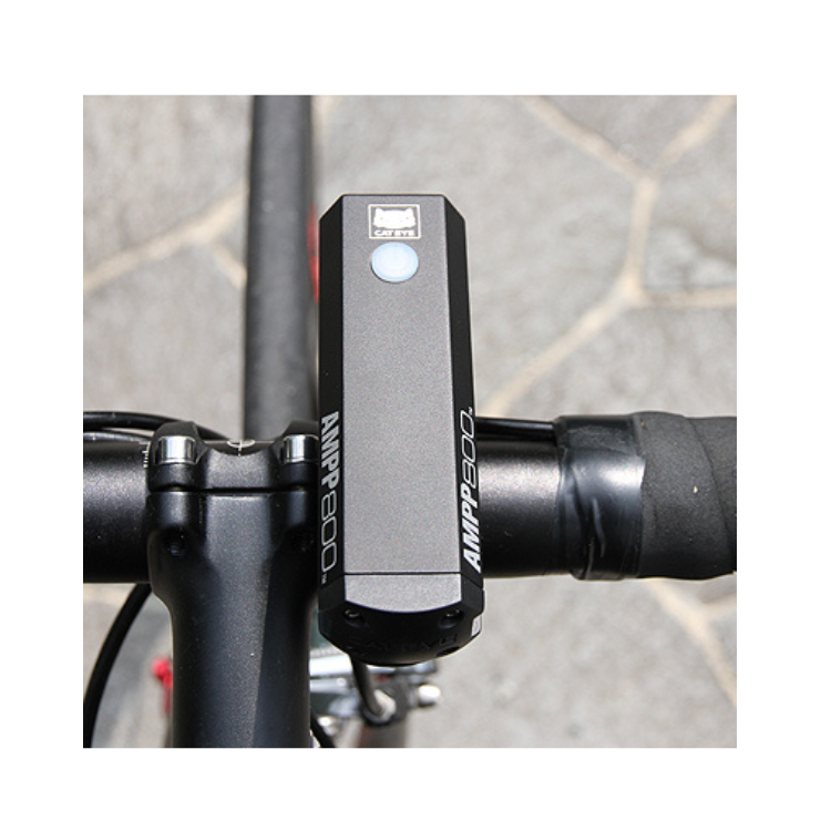 The AMPP800 bike light securely mounted on the handlebar, offering a bright, focused light for safer night cycling.