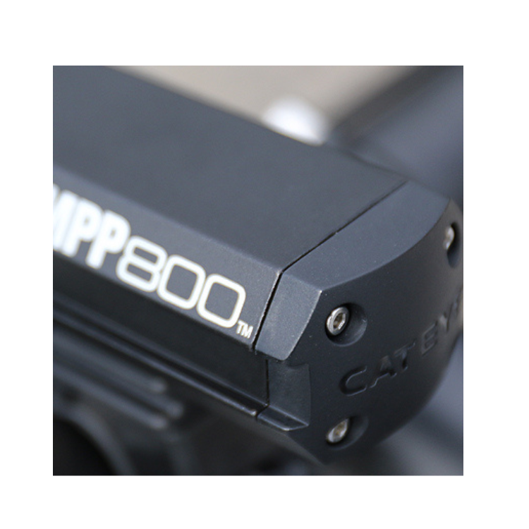 The AMPP800 front light featuring advanced LED technology for superior brightness, mounted securely on a bicycle for reliable night cycling.