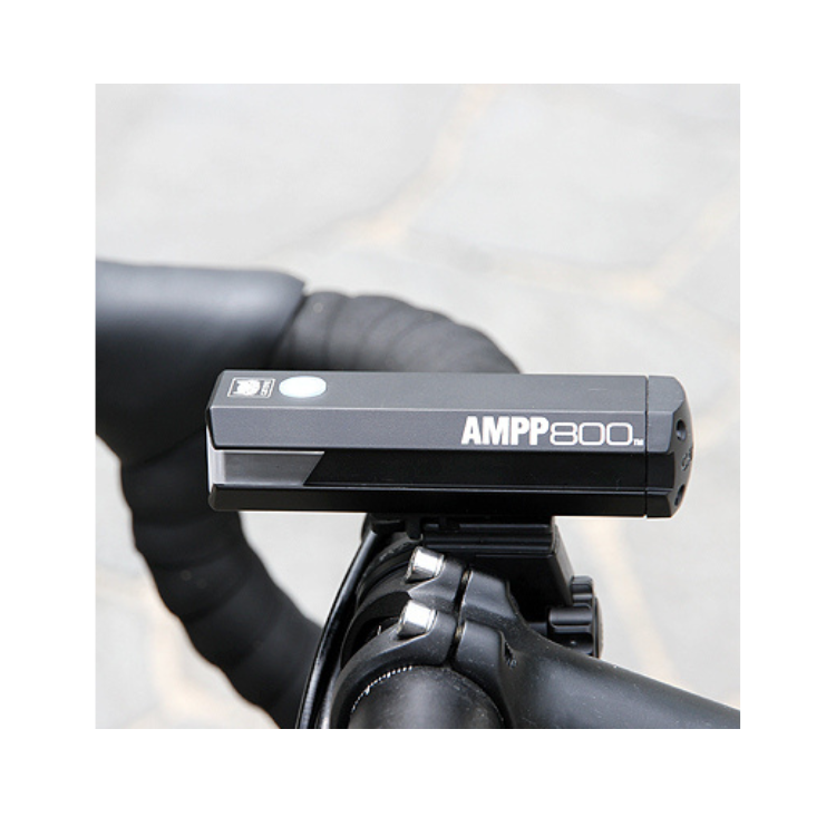 AMPP800 front bike light mounted on a bicycle, providing focused illumination for enhanced road safety during evening cycling adventures.