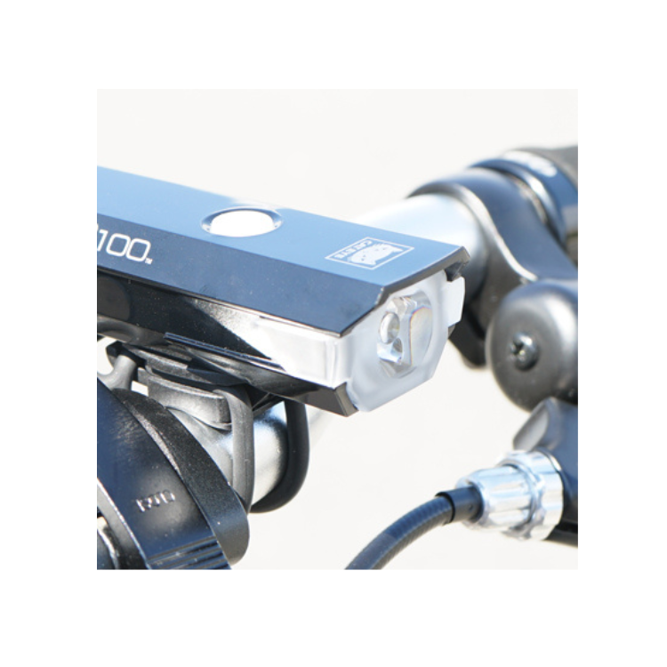 Cateye AMPP100 front bike light mounted on a handlebar, designed for optimal visibility and safety during cycling.