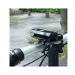 Close-up of the Cateye AMPP100 front bike light mounted on the handlebar of a bicycle, showing the light in its active position for clear illumination.
