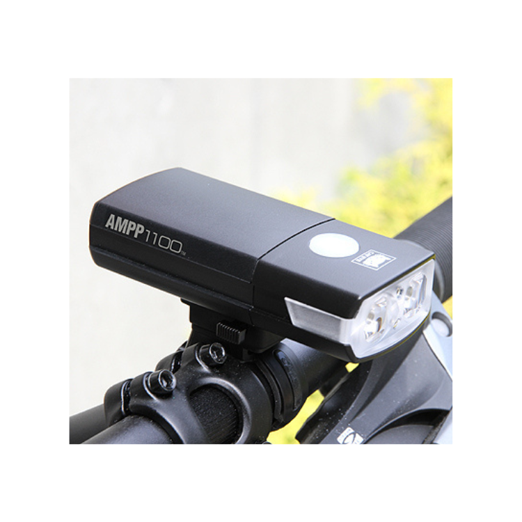 Cateye AMPP1100 mounted on a bike, providing powerful illumination for enhanced cycling visibility in low-light conditions.