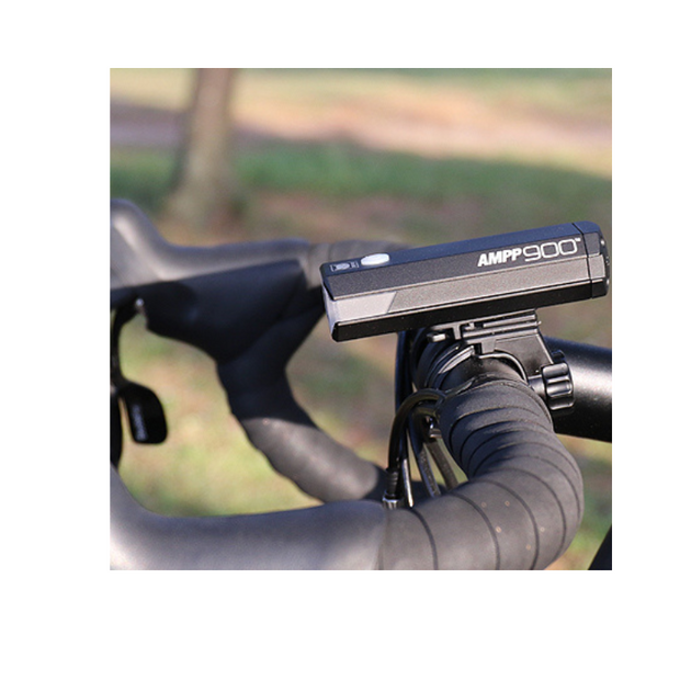 Cateye AMPP900 front light mounted on handlebars, offering 900 lumens for clear visibility.