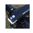 Cateye AMPP900 front LED light mounted on a bike, perfect for nighttime riding visibility.