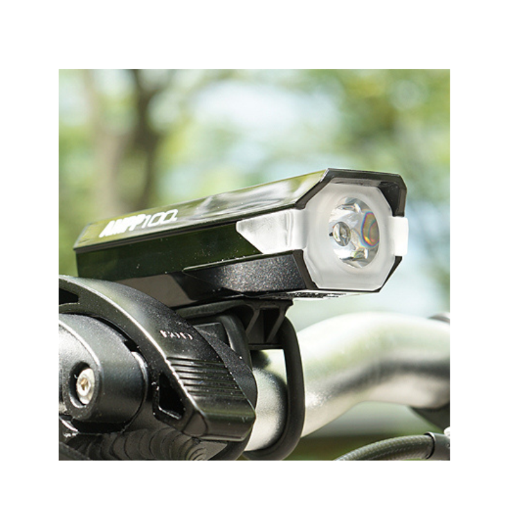 Close-up of Cateye AMPP 100 headlight mounted on a bike's handlebar, featuring its bright LED for enhanced visibility during cycling.