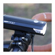 Cateye AMPP 2200 front bike light shining on a bicycle handlebar