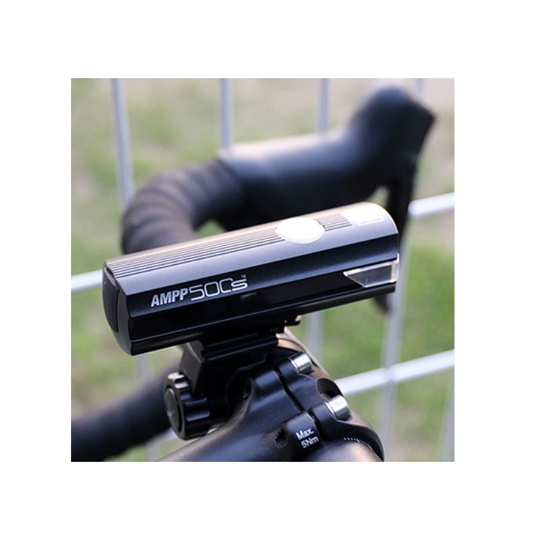 Cateye AMPP 500S front light mounted on bike handlebars, offering powerful illumination for safer cycling in low-light conditions.