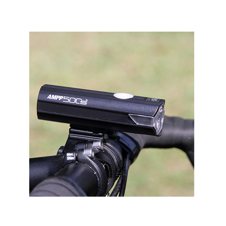 Cateye AMPP 500S front light firmly mounted on handlebars, providing bright and reliable illumination for enhanced visibility on the road.