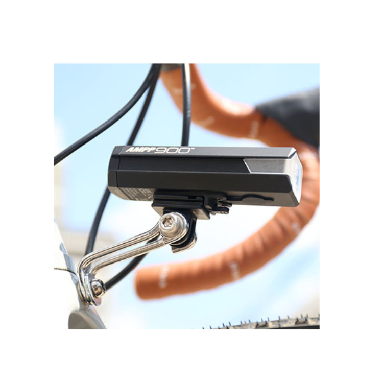 Cateye AMPP 900 front bike light mounted on a bike frame, providing powerful illumination with sleek design for enhanced visibility and safety during rides.