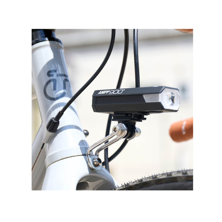 Cateye AMPP 900 front bike light mounted on handlebars, providing superior illumination for cyclists, ensuring high visibility for both day and night rides.
