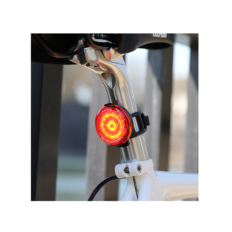 Cateye rear LED bike light mounted on a bike seat post, offering bright red light for enhanced visibility and safety during cycling.