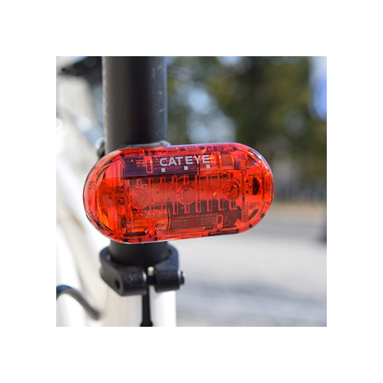 Cateye rear LED bike light mounted on the seat post of a bike, offering bright red visibility for safety in low-light conditions.