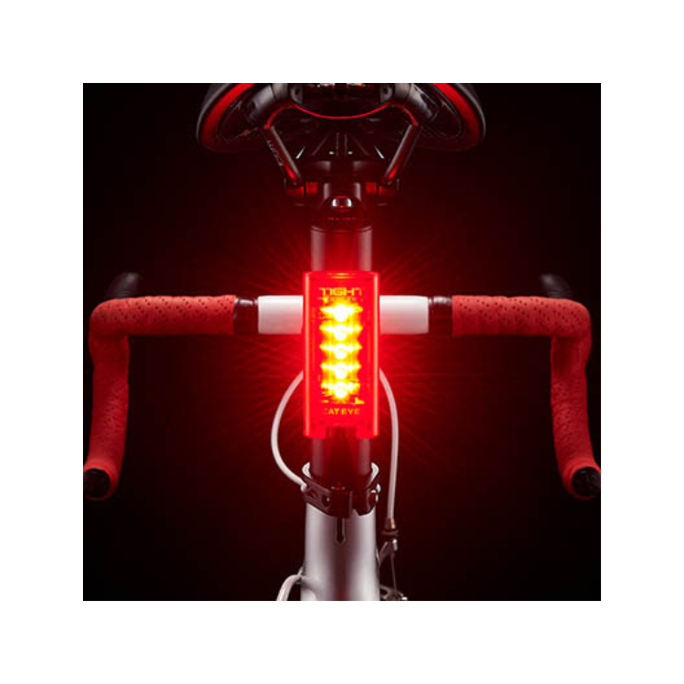 Cateye Tight Kinetic front bike light mounted on handlebars, featuring bright red LEDs for optimal visibility in low-light conditions.