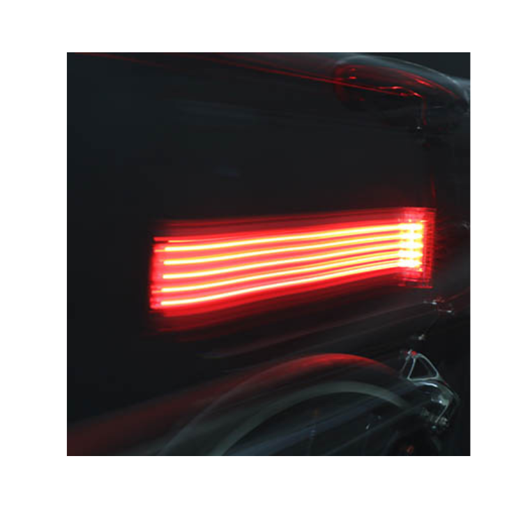 Cateye Tight Kinetic rear light showing bright LED light while in motion, creating a powerful red visibility for safety during cycling.
