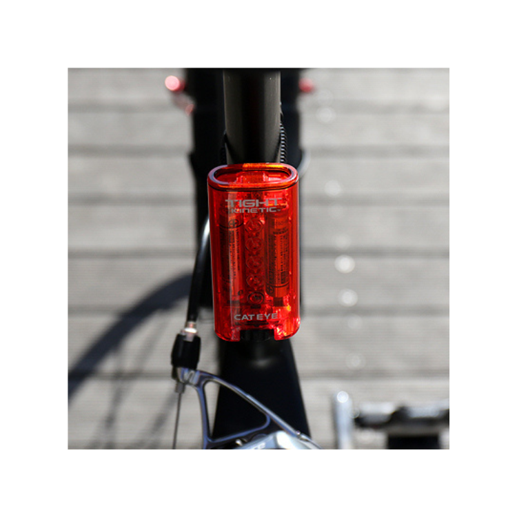 Cateye Tight Kinetic rear bike light mounted on a bicycle frame, showing its sleek design and bright red visibility for enhanced safety.