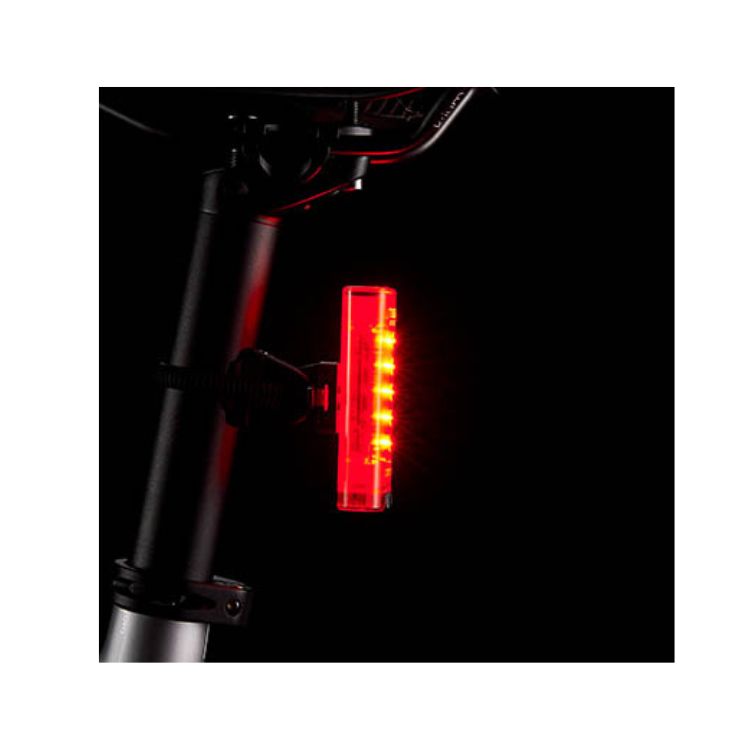 Cateye Tight Kinetic rear light mounted on a bike seat post, showcasing red LEDs for enhanced night-time visibility and cycling safety.
