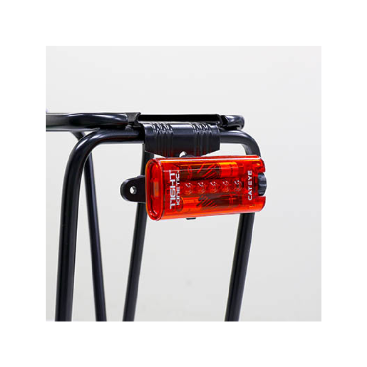 Cateye Tight Kinetic rear light mounted on a bike rack, demonstrating its easy attachment and bright red light for increased cyclist visibility.