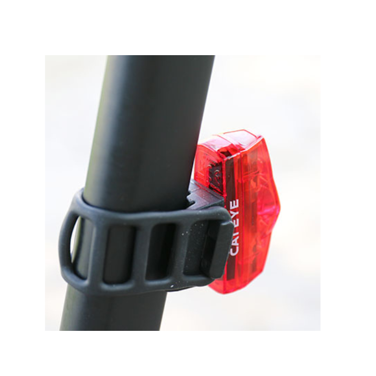 Cateye VIZ100 red rear bike light mounted on the seatpost of a bicycle with a secure rubber strap, providing enhanced visibility for safer cycling in low-light environments.