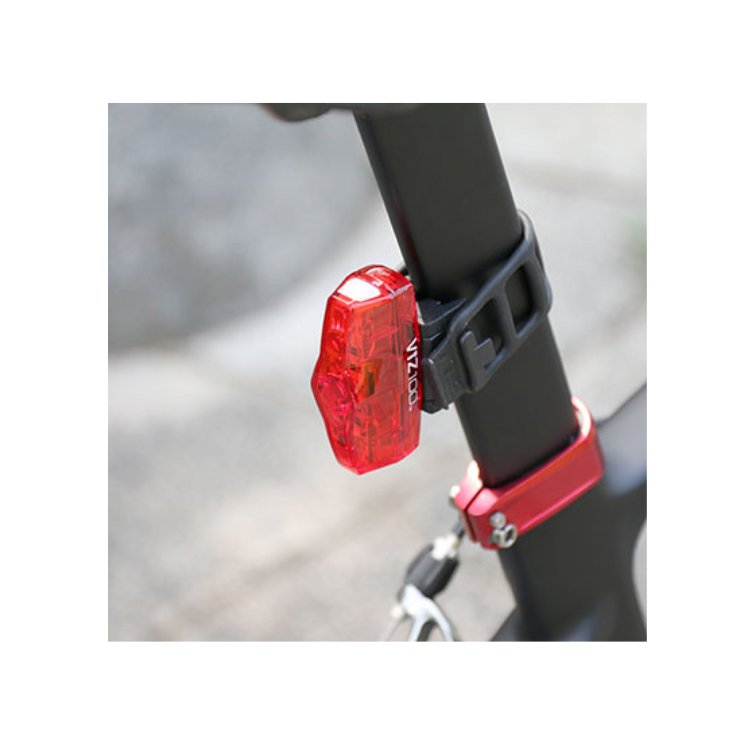 Cateye VIZ100 rear bike light mounted on a bicycle seatpost, providing clear red visibility for safety while riding.