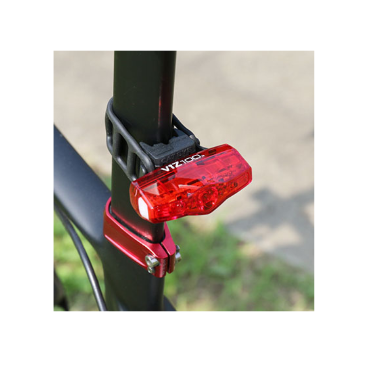 Cateye VIZ100 rear bike light mounted on the seatpost of a bicycle, providing visibility from behind with a clear red light.