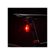  Cateye VIZ150 rear bike light with red LED on a bike saddle, glowing brightly in dark settings.