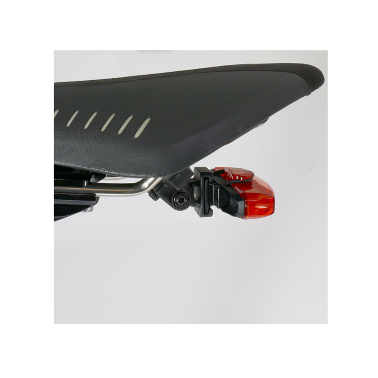 Cateye VIZ300 rear bike light securely mounted on the bike saddle for increased visibility and safety during night rides. Durable and compact design for effective illumination.