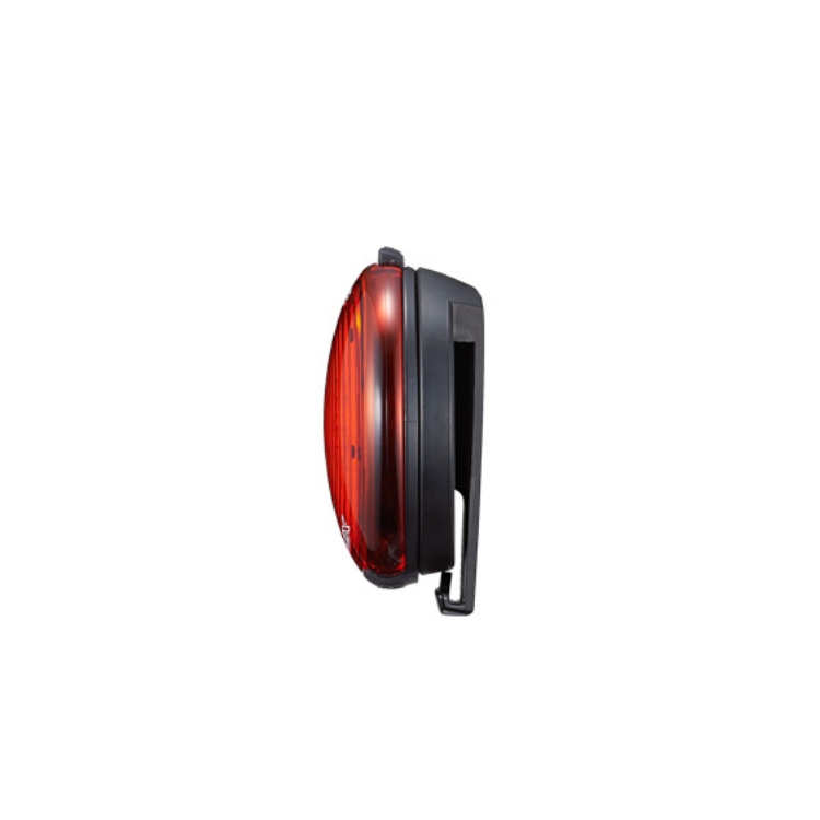 Cateye wearable LED light viewed from the side, emphasizing its compact design and bright red visibility for safety.