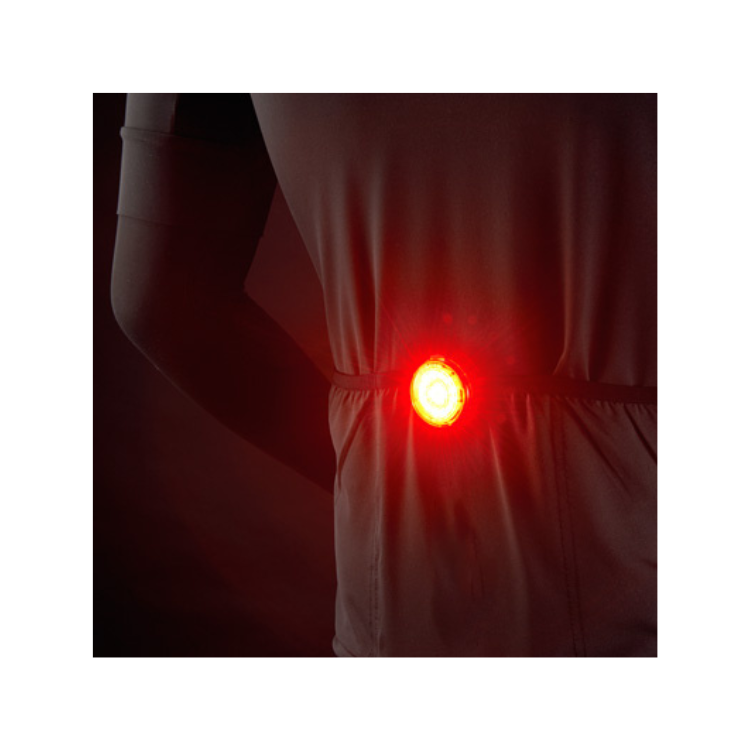 Cateye wearable LED light mounted on a waist strap, improving safety with visible red lighting in dark environments.