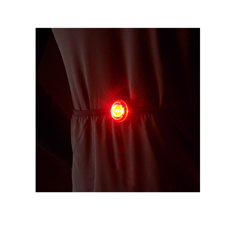 Cateye wearable LED light attached to a cyclist's waist, offering additional visibility for pedestrians and cyclists in the dark.