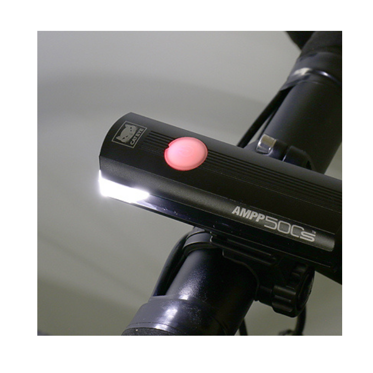 Close-up view of Cateye 500s AMPP 50CS bike light with a visible power button for ease of use.