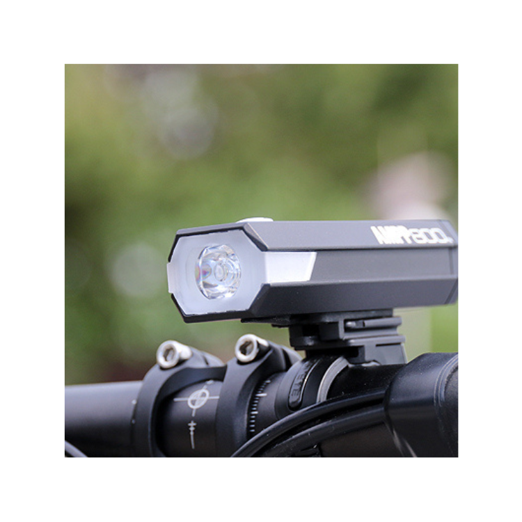 The AMPP800 front bike light mounted on a bike, showcasing its practical use in enhancing visibility during nighttime rides.