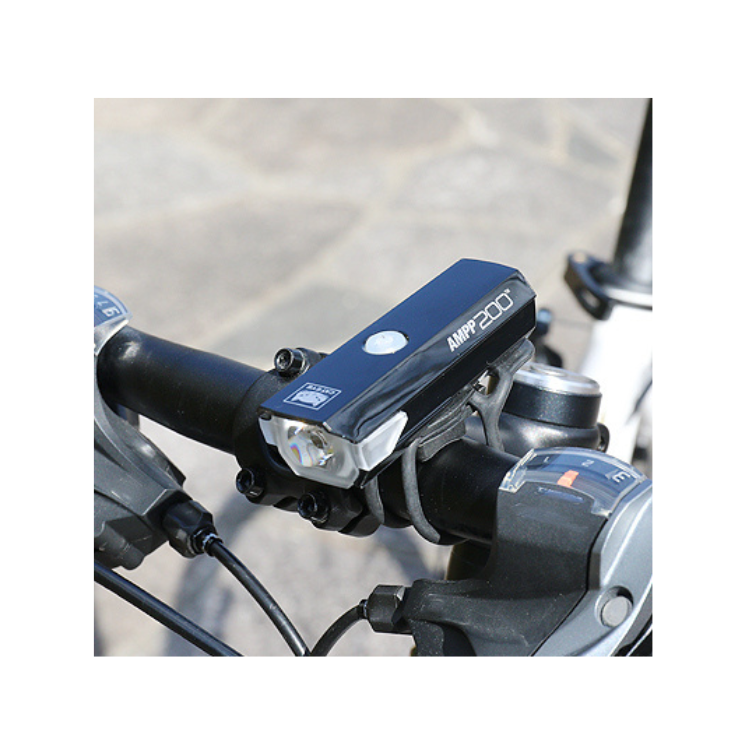 Cateye AMPP 200 front bike light in action, mounted on a bike for enhanced nighttime cycling safety.