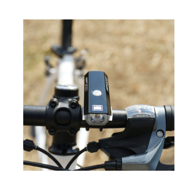 Cateye AMPP 200 front bike light mounted on handlebar, perfect for night cycling.