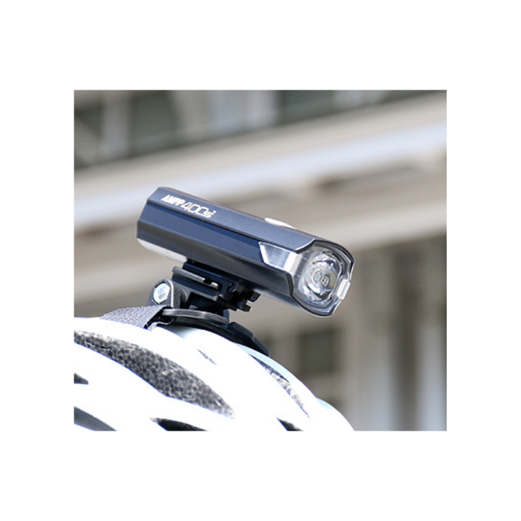 Cateye AMPP 400s front bike light mounted on a helmet for enhanced visibility while cycling.