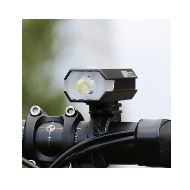 Cateye front bike light mounted on a handlebar, providing excellent illumination for cycling at night with its bright LED performance.