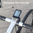 Bicycle speedometer attached to a bike handlebar on a wooden surface