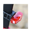 Cateye VIZ150 bike light in action, illuminating the rear of a bicycle with bright red LED lights for added safety.